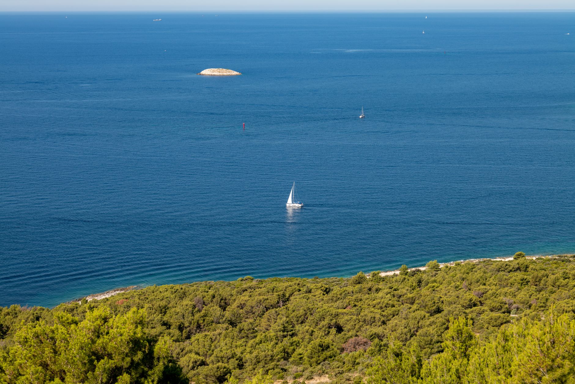 A tranquil scene of a sailboat on the Adriatic Sea near Primošten, Croatia.